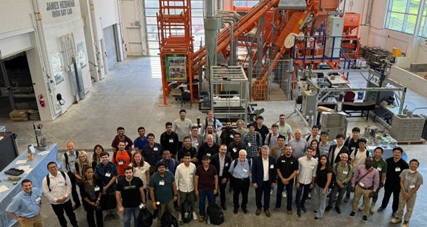 A group of people standing in a factory